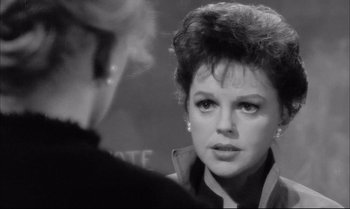 Movie still from “A Child Is Waiting” (1963), directed by John Cassavetes – An old black and white photo of a woman looking at the camera; Close Up shot, Over the shoulder angle