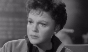 Movie still from “A Child Is Waiting” (1963), directed by John Cassavetes – An old black and white photo of a woman looking at the camera; Close Up shot, High angle