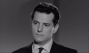 Movie still from “A Child Is Waiting” (1963), directed by John Cassavetes – Black and white photograph of a man in a suit and tie; Close Up shot, Low angle