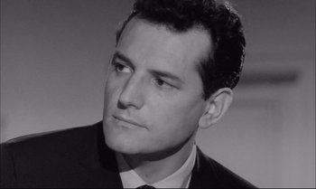 Movie still from “A Child Is Waiting” (1963), directed by John Cassavetes – A black and white photo of a man in a suit and tie; Close Up shot, Low angle