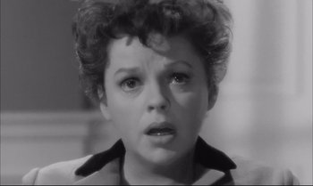 Movie still from “A Child Is Waiting” (1963), directed by John Cassavetes – An old photo of a woman looking sad; Close Up shot, High angle