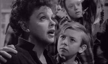Movie still from “A Child Is Waiting” (1963), directed by John Cassavetes – A woman and two young boys looking up at the sky; Close Up shot, Low angle