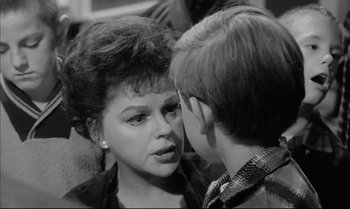 Movie still from “A Child Is Waiting” (1963), directed by John Cassavetes – An older woman and a young boy talking to each other; Close Up shot, Over the shoulder angle