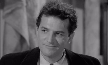Movie still from “A Child Is Waiting” (1963), directed by John Cassavetes – Black and white photograph of a man with curly hair; Close Up shot, High angle