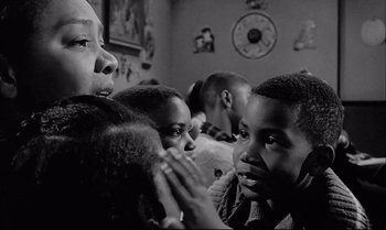 Movie still from “A Child Is Waiting” (1963), directed by John Cassavetes – A group of children sitting together in a room; Close Up shot, Over the shoulder angle