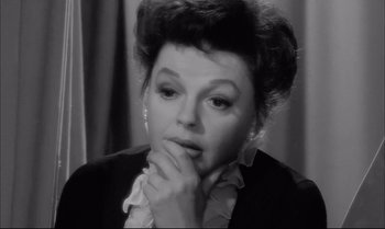 Movie still from “A Child Is Waiting” (1963), directed by John Cassavetes – An old photo of a woman with a hand on her chin; Close Up shot, High angle