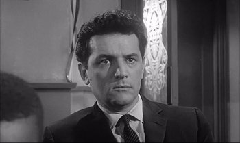 Movie still from “A Child Is Waiting” (1963), directed by John Cassavetes – Black and white photograph of a man wearing a suit and tie; Close Up shot, Low angle