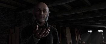 Movie still from “A Christmas Carol” (2009), directed by Robert Zemeckis – An old man is holding his hands out to the camera; Close Up shot, Over the shoulder angle