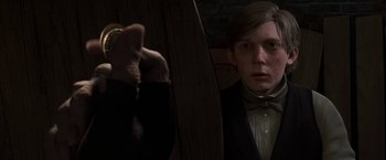Movie still from “A Christmas Carol” (2009), directed by Robert Zemeckis – A man in a suit and bow tie looking at himself in the mirror; Close Up shot, Over the shoulder angle