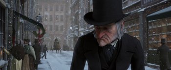 Movie still from “A Christmas Carol” (2009), directed by Robert Zemeckis – An old man in a top hat and a black coat; Medium shot, Low angle