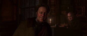 Movie still from “A Christmas Carol” (2009), directed by Robert Zemeckis – A man in a coat and hat is in a dimly - lit room; Close Up shot, Low angle