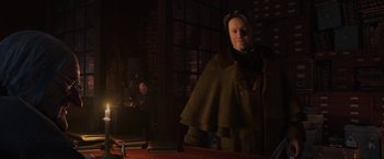 Movie still from “A Christmas Carol” (2009), directed by Robert Zemeckis – A woman in a brown coat standing next to a man; Medium shot, Over the shoulder angle
