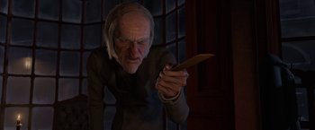 Movie still from “A Christmas Carol” (2009), directed by Robert Zemeckis – An old man holding a knife in his hand; Close Up shot, Low angle