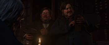 Movie still from “A Christmas Carol” (2009), directed by Robert Zemeckis – A couple of men standing next to each other near a lit candle; Medium shot, Low angle