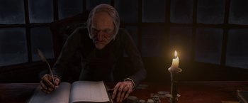 Movie still from “A Christmas Carol” (2009), directed by Robert Zemeckis – An old man sitting at a table reading a book; Medium shot, Low angle