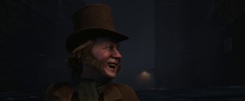 Movie still from “A Christmas Carol” (2009), directed by Robert Zemeckis – A man wearing a top hat and a scarf laughing; Close Up shot, Over the shoulder angle