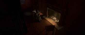 Movie still from “A Christmas Carol” (2009), directed by Robert Zemeckis – A person sitting in a chair in front of a fireplace; Extreme Wide shot, High angle