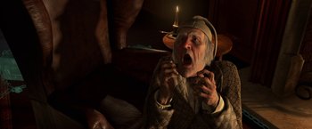 Movie still from “A Christmas Carol” (2009), directed by Robert Zemeckis – An old man is sitting on a couch with a candle in the background; Close Up shot, High angle
