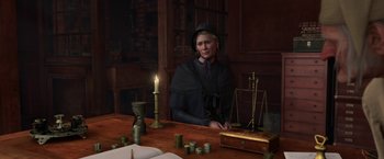 Movie still from “A Christmas Carol” (2009), directed by Robert Zemeckis – A woman sitting at a table in front of stacks of coins; Medium shot, Over the shoulder angle