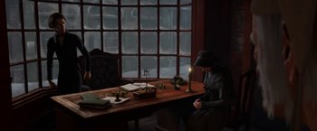 Movie still from “A Christmas Carol” (2009), directed by Robert Zemeckis – A man sitting at a desk with a candle; Wide shot, High angle