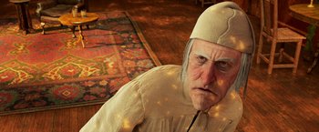 Movie still from “A Christmas Carol” (2009), directed by Robert Zemeckis – An old man wearing a white hat sitting on the floor; Close Up shot, High angle