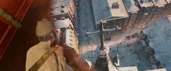 Movie still from “A Christmas Carol” (2009), directed by Robert Zemeckis – An aerial view of a man looking down at a cross; Extreme Wide shot, Overhead angle