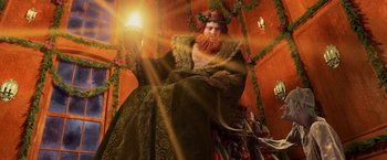 Movie still from “A Christmas Carol” (2009), directed by Robert Zemeckis – An image of a man dressed like a wizard holding a light; Medium shot, Low angle
