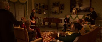 Movie still from “A Christmas Carol” (2009), directed by Robert Zemeckis – A group of people sitting in a living room; Wide shot, High angle