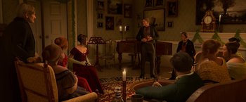 Movie still from “A Christmas Carol” (2009), directed by Robert Zemeckis – A group of people sitting in a living room; Wide shot, High angle