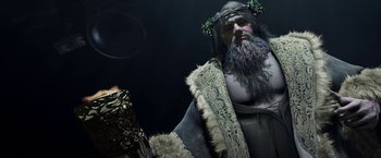 Movie still from “A Christmas Carol” (2009), directed by Robert Zemeckis – A man dressed as a viking holding a book; Medium shot, Low angle