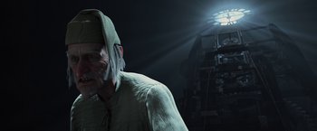 Movie still from “A Christmas Carol” (2009), directed by Robert Zemeckis – A man with a hat on his head is standing in the dark; Close Up shot, Low angle