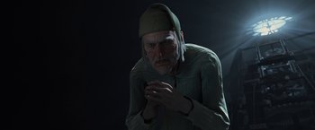 Movie still from “A Christmas Carol” (2009), directed by Robert Zemeckis – An old man wearing a green hat is smoking a cigarette; Close Up shot, Over the shoulder angle