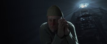 Movie still from “A Christmas Carol” (2009), directed by Robert Zemeckis – An old man wearing a hat is sitting in the dark; Close Up shot, Low angle