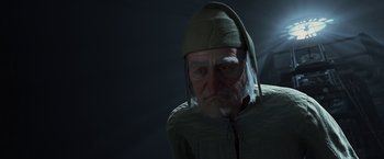 Movie still from “A Christmas Carol” (2009), directed by Robert Zemeckis – An old man wearing a green hat and a green shirt; Close Up shot, Over the shoulder angle