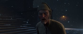Movie still from “A Christmas Carol” (2009), directed by Robert Zemeckis – An old man wearing a hat with a snow background; Medium shot, Low angle