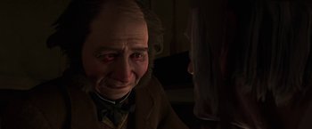 Movie still from “A Christmas Carol” (2009), directed by Robert Zemeckis – An old man is crying in a dark room; Close Up shot, Over the shoulder angle