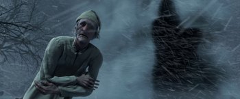 Movie still from “A Christmas Carol” (2009), directed by Robert Zemeckis – An old man standing in front of a wall; Medium shot, High angle