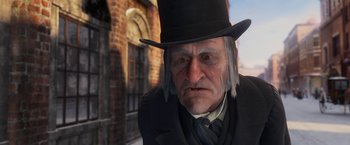 Movie still from “A Christmas Carol” (2009), directed by Robert Zemeckis – An old man wearing a top hat and a black suit; Close Up shot, Over the shoulder angle