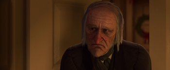 Movie still from “A Christmas Carol” (2009), directed by Robert Zemeckis – An old man wearing a suit and tie; Close Up shot, Low angle