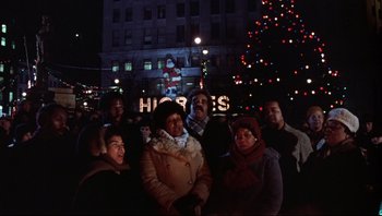 Movie still from “A Christmas Story” (1983), directed by Bob Clark – A group of people standing in front of a christmas tree; Wide shot, Low angle