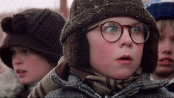 Movie still from “A Christmas Story” (1983), directed by Bob Clark – A young boy wearing glasses and wearing a hat; Close Up shot, Low angle