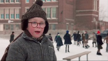 Movie still from “A Christmas Story” (1983), directed by Bob Clark – A young boy wearing glasses and a winter hat; Close Up shot, Low angle