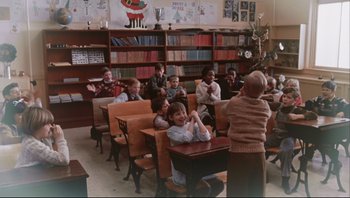 Movie still from “A Christmas Story” (1983), directed by Bob Clark – A group of children sitting at a table in a classroom; Wide shot, High angle
