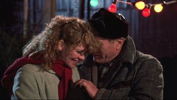 Movie still from “A Christmas Story” (1983), directed by Bob Clark – An older man and a younger woman smiling at each other; Close Up shot, Over the shoulder angle