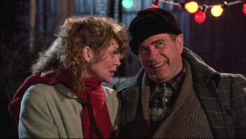 Movie still from “A Christmas Story” (1983), directed by Bob Clark – A man and a woman standing next to each other on a street; Close Up shot, Over the shoulder angle