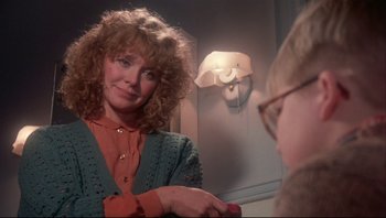 Movie still from “A Christmas Story” (1983), directed by Bob Clark – A woman is looking at her reflection in a mirror; Close Up shot, Over the shoulder angle