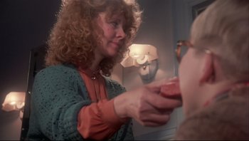 Movie still from “A Christmas Story” (1983), directed by Bob Clark – A woman is holding something in her hand; Close Up shot, Over the shoulder angle