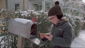Movie still from “A Christmas Story” (1983), directed by Bob Clark – A young boy is checking his mail in the snow; Medium shot, Low angle