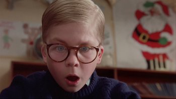 Movie still from “A Christmas Story” (1983), directed by Bob Clark – A young boy wearing glasses looking surprised; Close Up shot, Low angle