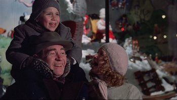 Movie still from “A Christmas Story” (1983), directed by Bob Clark – An older man holding a young child on his shoulders; Medium shot, Low angle